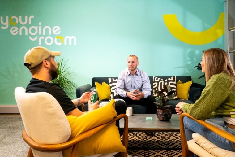 Bright, colorful interior wall graphics that say, "Your engine room" in a meeting/reception area.